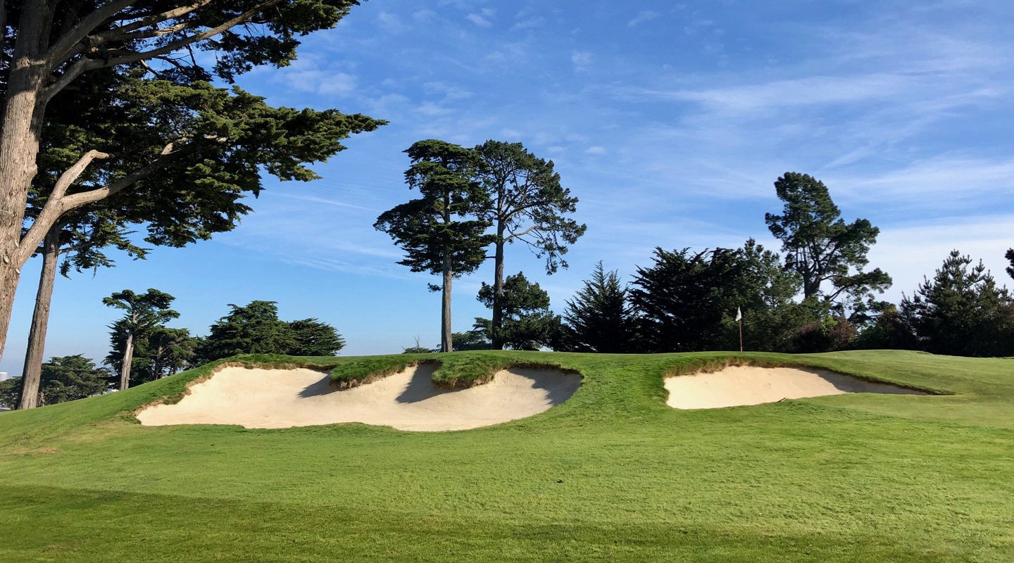 The bunkers waiting on the left for tugged tee balls
