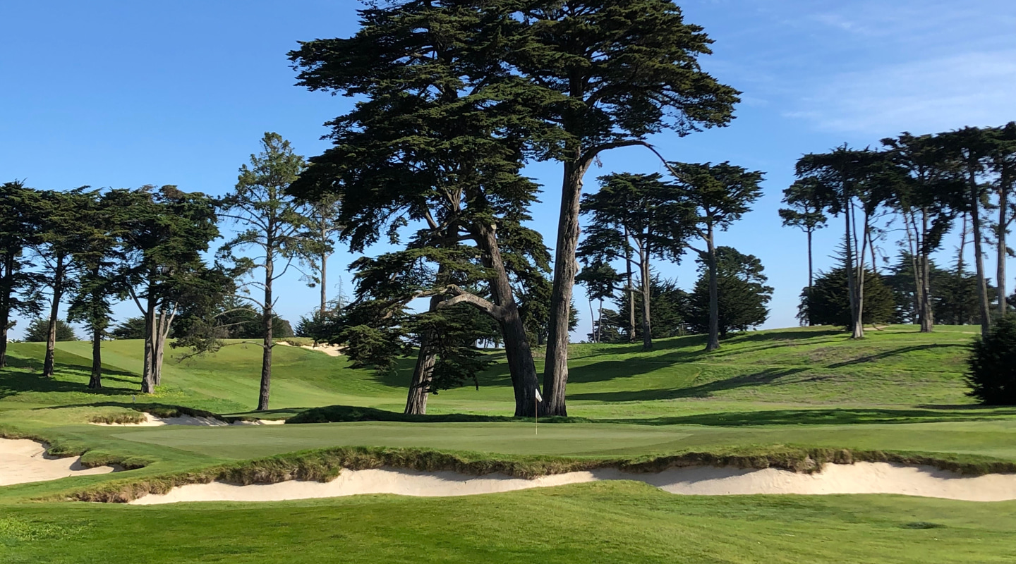 Bunkers guard the left of the contoured putting surface