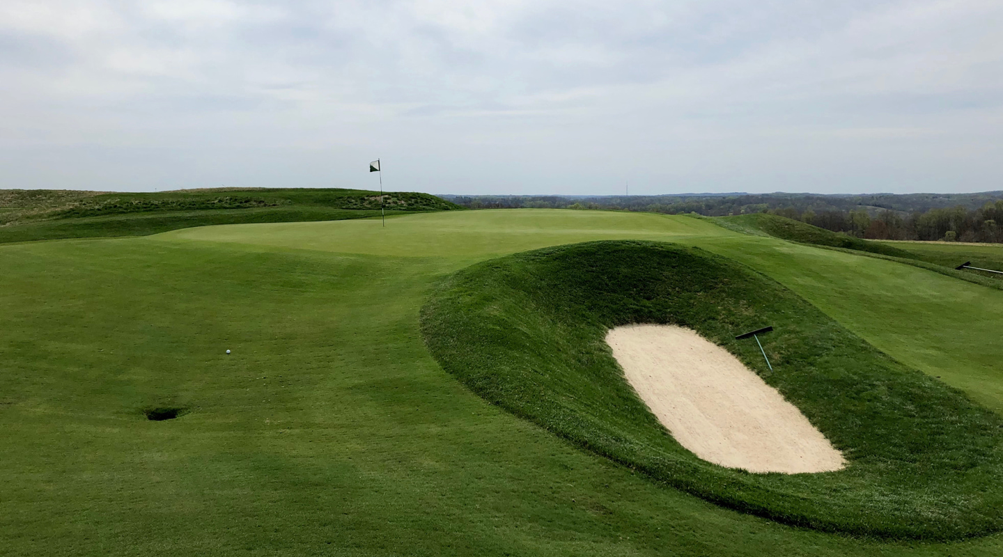 The pot bunker short of green on the par-4 10th