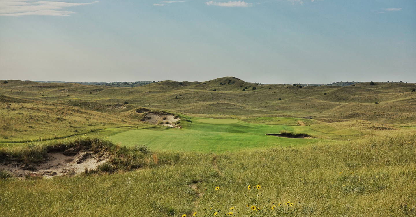 The fairway runs away from the tee toward the bunker right The fairway runs away from the tee toward the bunker right